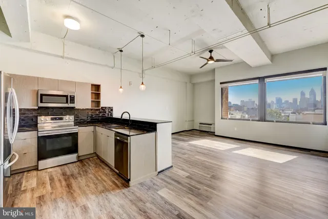 a kitchen with stainless steel appliances granite countertop a stove and a refrigerator