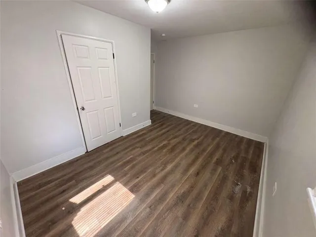 a view of an empty room and wooden floor