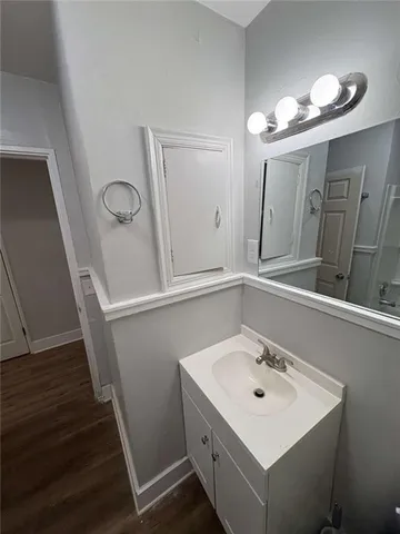 a bathroom with a sink a mirror and vanity