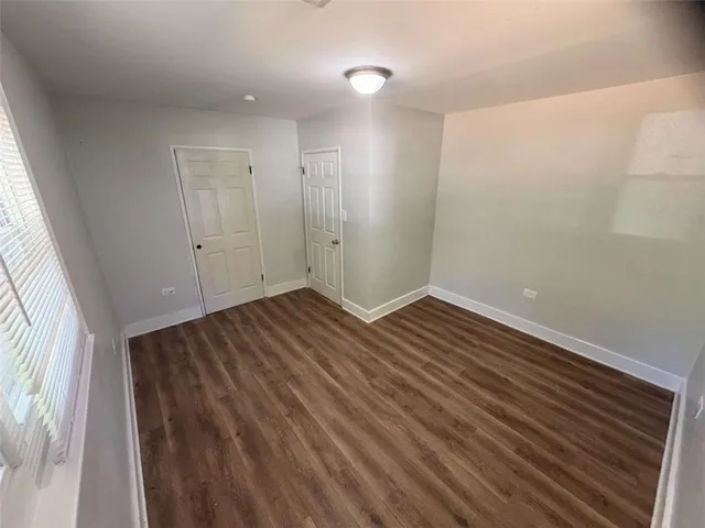 a view of room with wooden floor and window