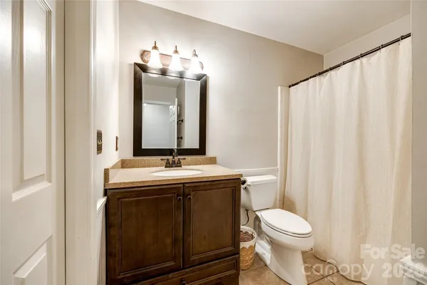 a bathroom with a toilet a sink and a mirror