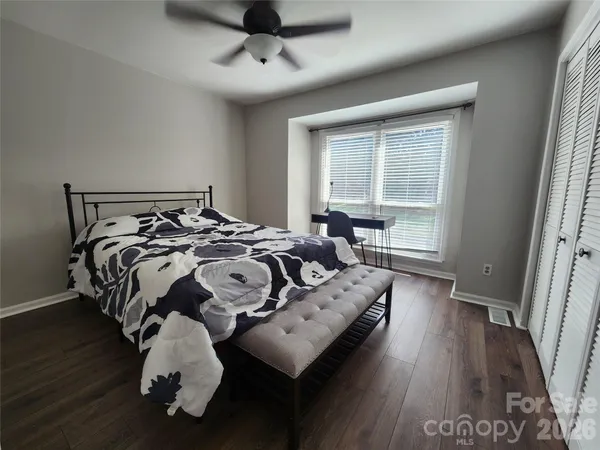 a bed sitting in a bedroom next to a window