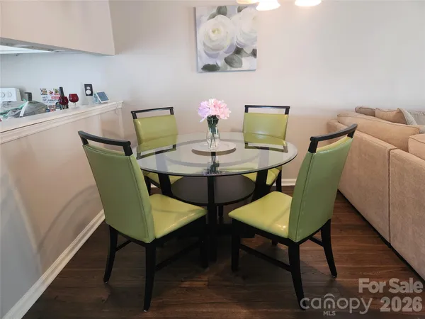 a view of a dining room with furniture and wooden floor