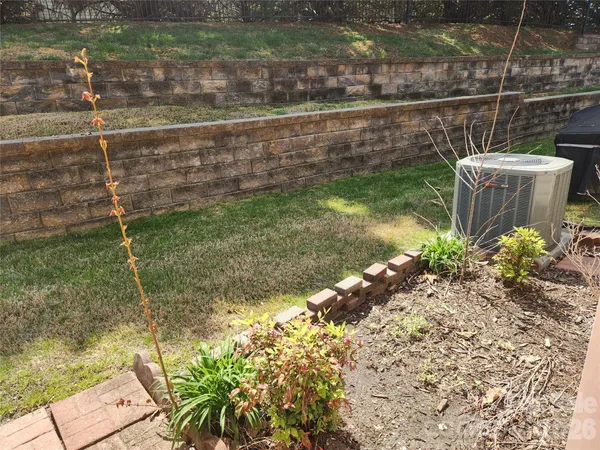 a backyard of a house with lots of green space and fountain