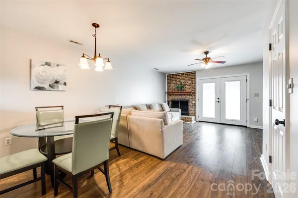a living room with furniture and a chandelier