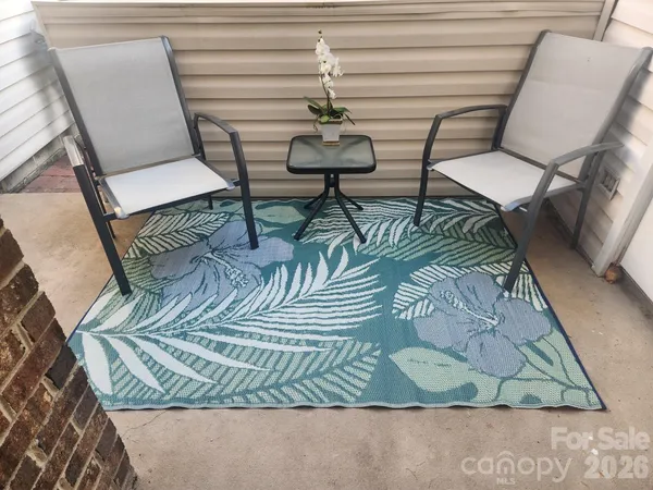 a balcony with table and chairs