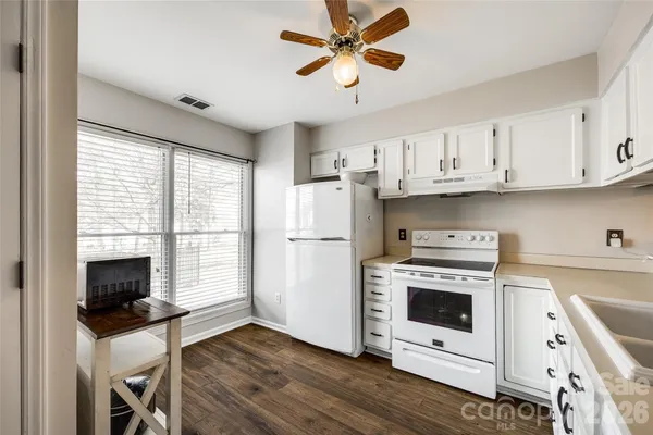 a kitchen with stainless steel appliances white cabinets and a stove