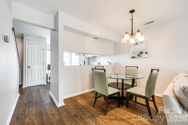 a view of a dining room with furniture wooden floor and a chandelier