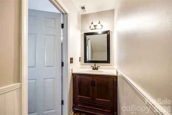 a bathroom with mirror and sink
