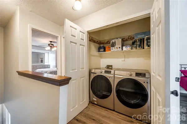 a view of a hallway with washer and dryer