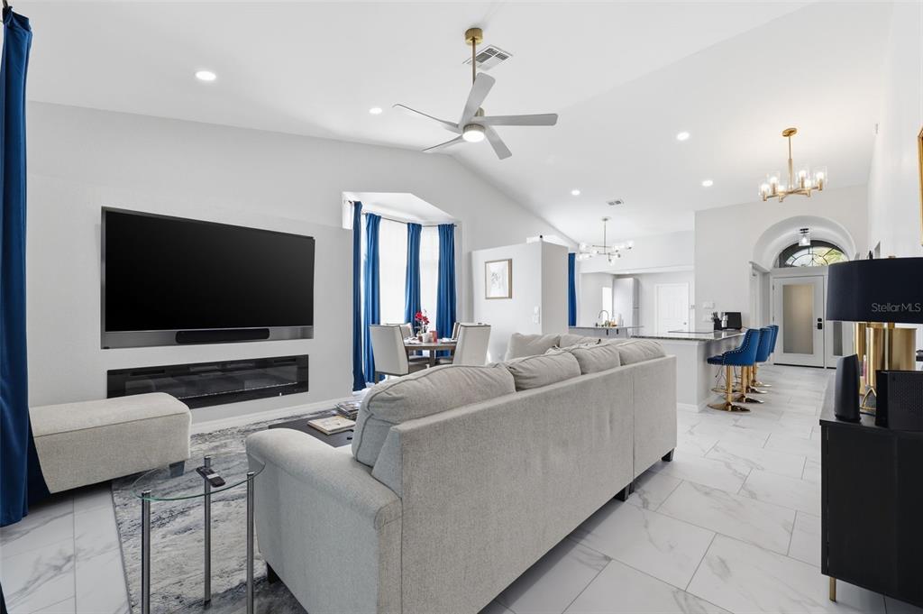 9376 French Quarters Circle Weeki Wachee, FL 34613 - Photo 11 of 43 a living room with furniture and a flat screen tv