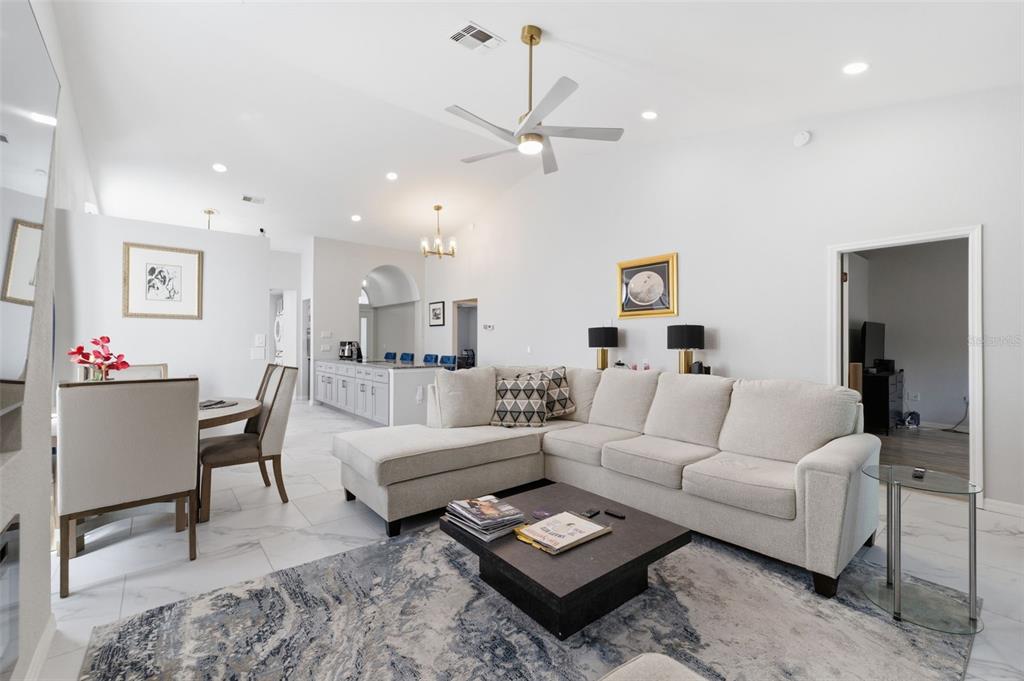 9376 French Quarters Circle Weeki Wachee, FL 34613 - Photo 12 of 43 a living room with furniture a rug and a chandelier