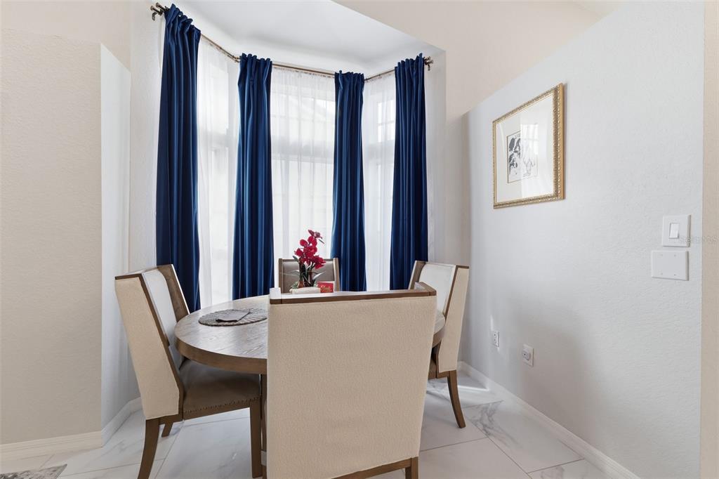 9376 French Quarters Circle Weeki Wachee, FL 34613 - Photo 13 of 43 a view of a dining room with furniture and window