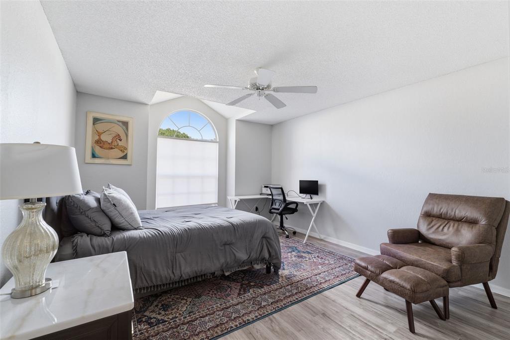 9376 French Quarters Circle Weeki Wachee, FL 34613 - Photo 16 of 43 a bedroom with a bed and wooden floor