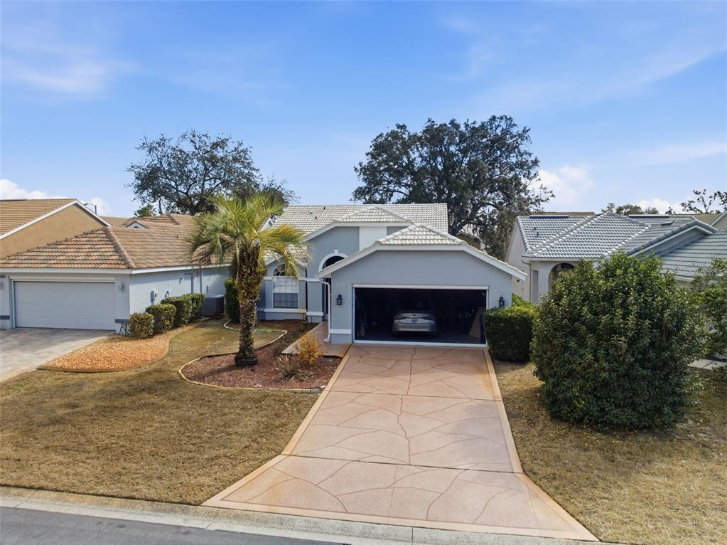 9376 French Quarters Circle Weeki Wachee, FL 34613 - Photo 22 of 43 a front view of a house with yard
