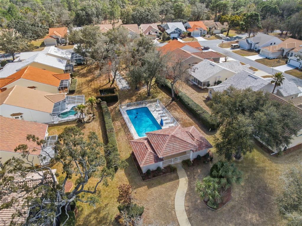 9376 French Quarters Circle Weeki Wachee, FL 34613 - Photo 33 of 43 an aerial view of a house with a yard basket ball court and outdoor seating