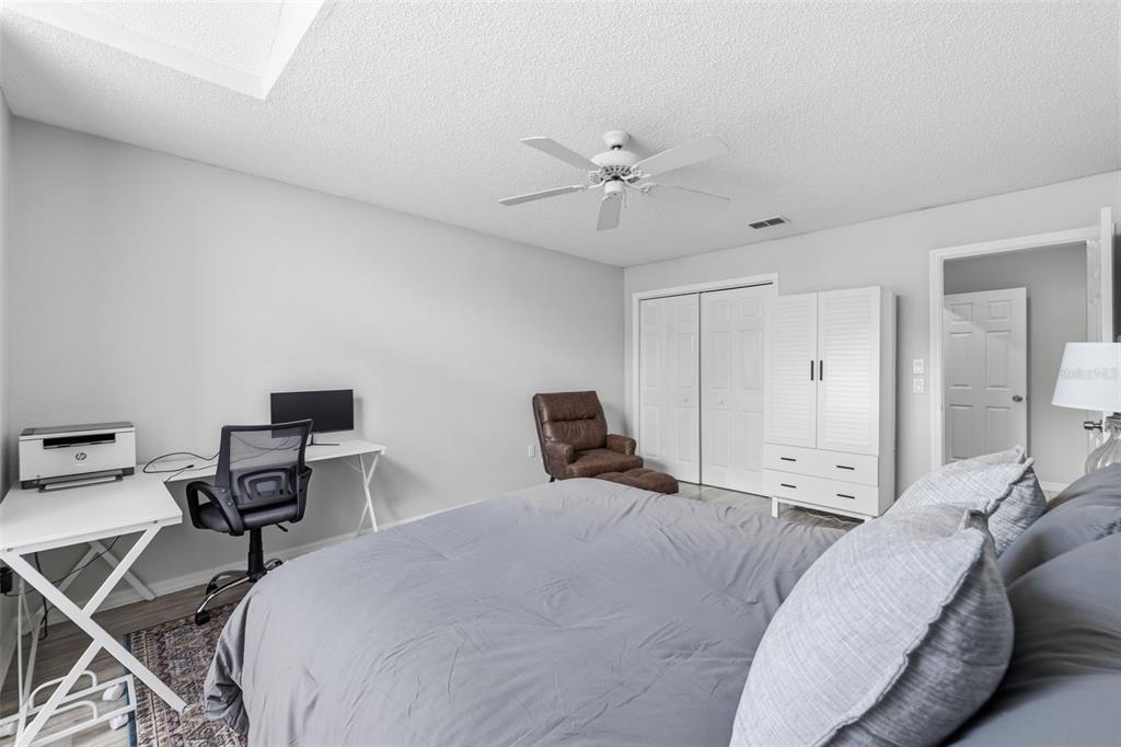 9376 French Quarters Circle Weeki Wachee, FL 34613 - Photo 41 of 43 a bedroom with a bed and a chandelier