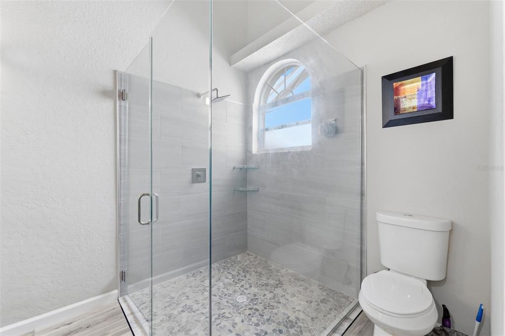 9376 French Quarters Circle Weeki Wachee, FL 34613 - Photo 42 of 43 a bathroom with a toilet and a shower