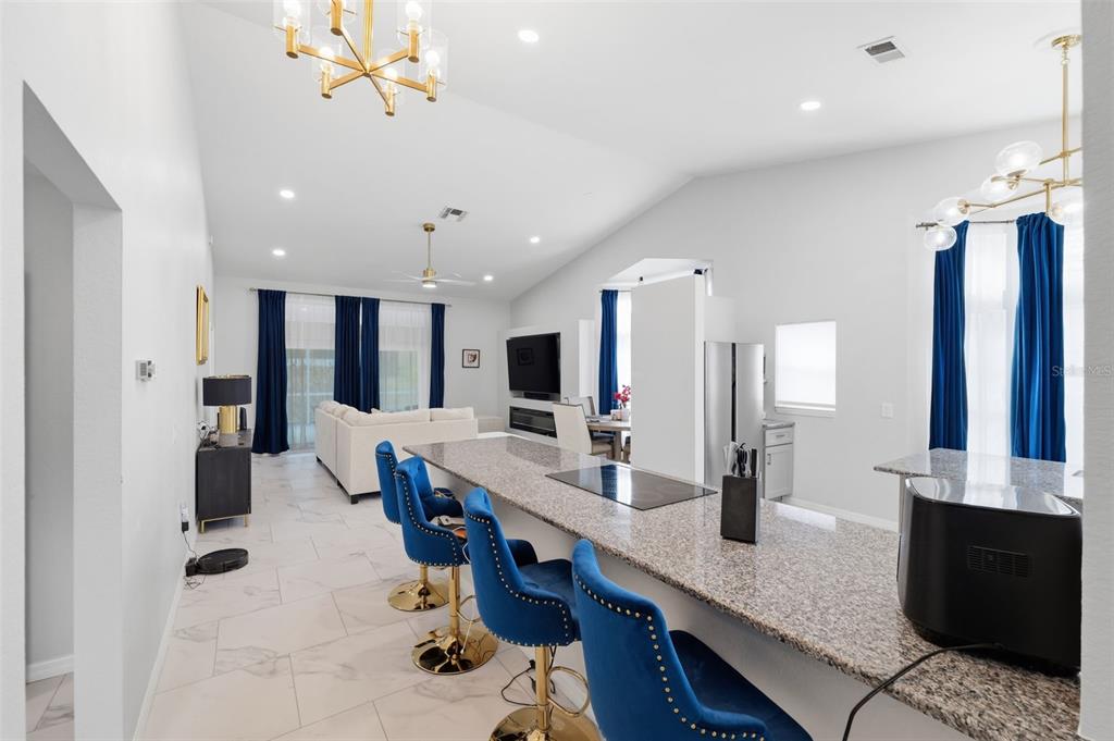 9376 French Quarters Circle Weeki Wachee, FL 34613 - Photo 5 of 43 a large kitchen with kitchen island a sink stainless steel appliances and cabinets