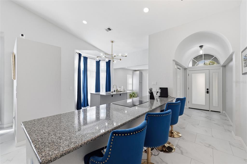9376 French Quarters Circle Weeki Wachee, FL 34613 - Photo 6 of 43 a living room with granite countertop furniture and a chandelier