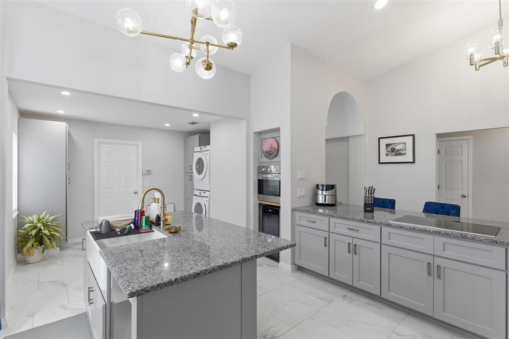 9376 French Quarters Circle Weeki Wachee, FL 34613 - Photo 9 of 43 a kitchen with a granite countertop sink and a refrigerator