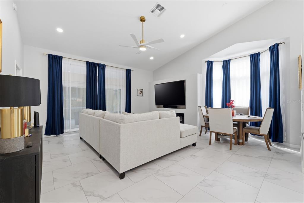 9376 French Quarters Circle Weeki Wachee, FL 34613 - Photo 10 of 43 a living room with furniture and a flat screen tv