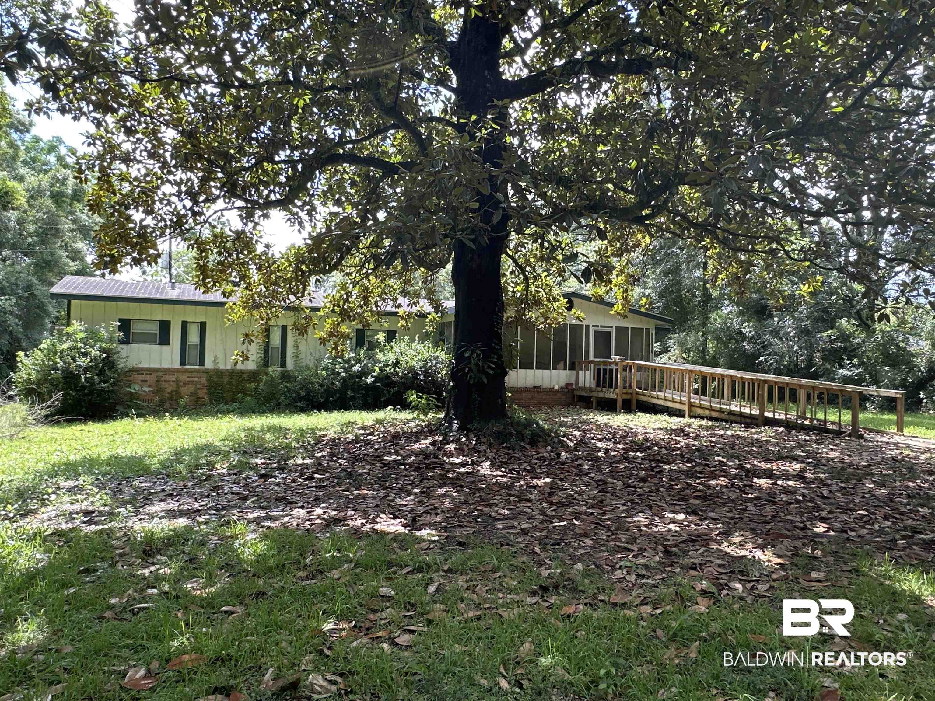 1850 Repoll Drive Mobile, AL 36695 - Photo 18 of 26 View of front of home with a sunroom and a wooden deck