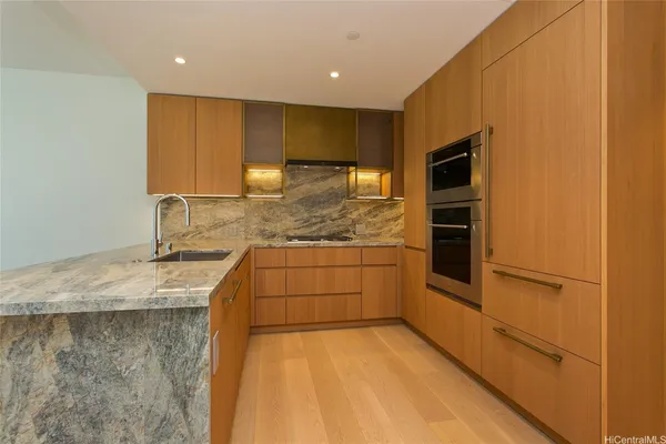 a kitchen with a sink and refrigerator