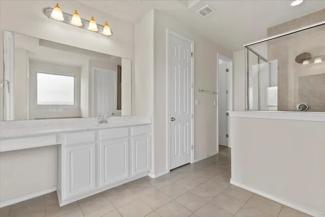 a view of a bathroom with double vanity sink and a mirror
