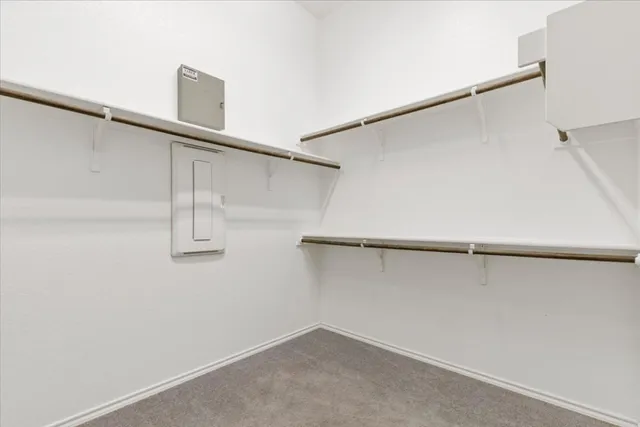 a view of small space with racks on the wall and a window