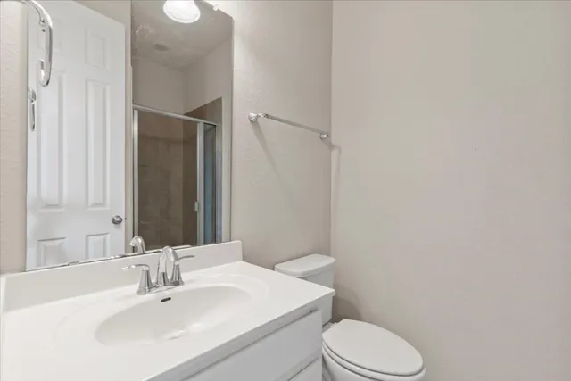 a bathroom with a sink toilet and mirror