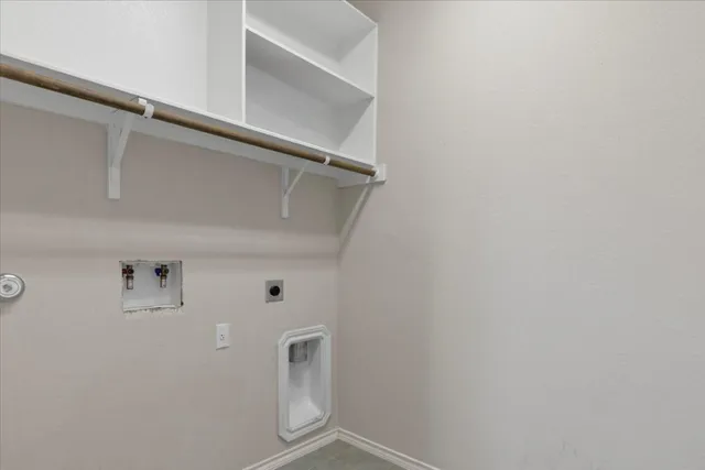 a view of storage and utility room with racks on the wall