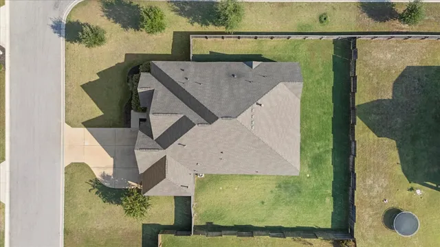 an aerial view of a house with a yard