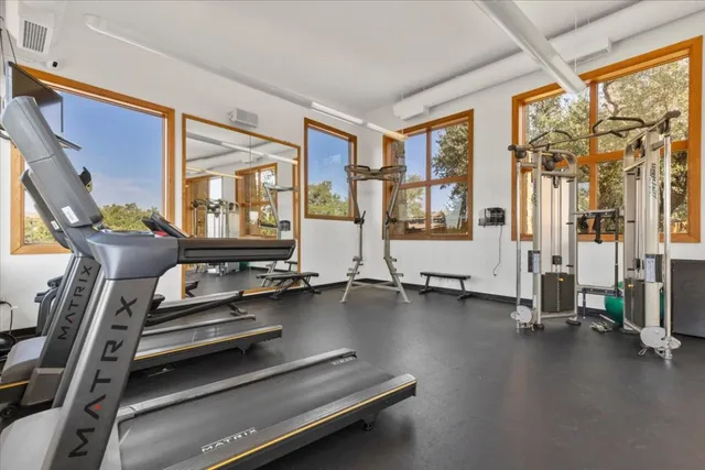 a room with gym equipment and a large window