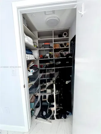 a spacious bathroom with a granite countertop sink a toilet and mirror