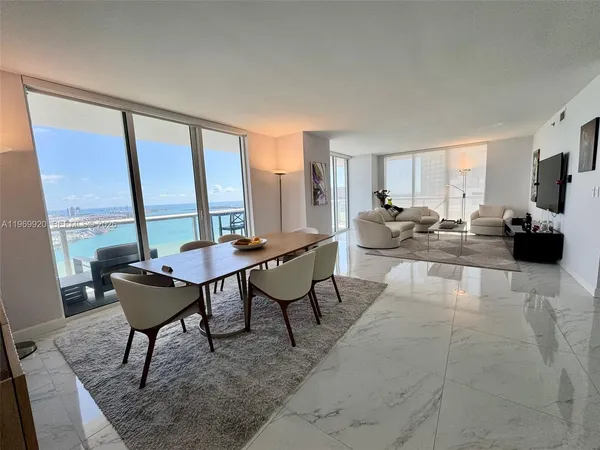 a living room with furniture and large windows