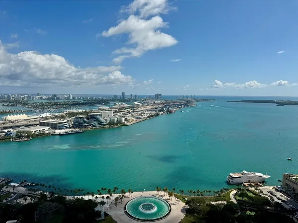 a living room with couches and a fireplace with wooden floor