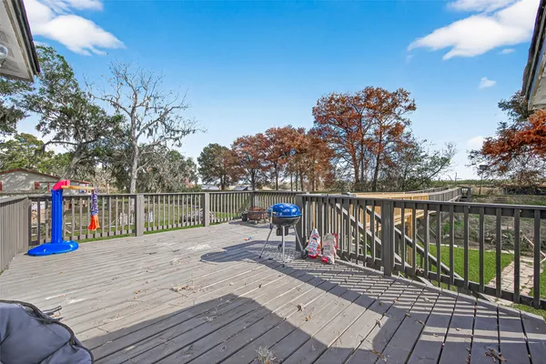 a view of stairs and deck with wooden floor and fence