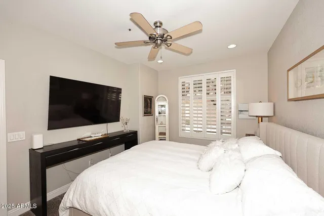 a bedroom with a bed and a flat screen tv