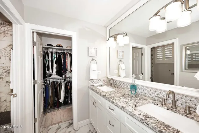 a bathroom with a granite countertop sink mirror and