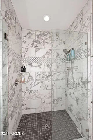 a bedroom with a bed a flat screen tv and a fireplace