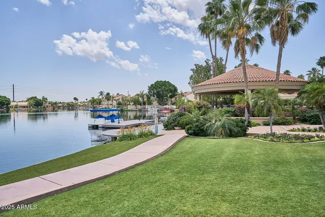 an aerial view of residential houses with outdoor space and lake view