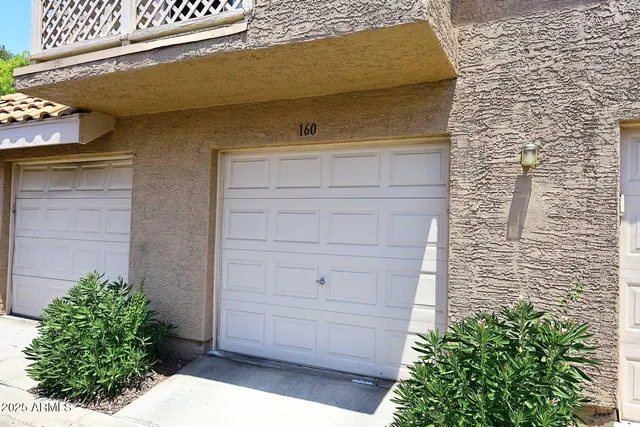 a kitchen with stainless steel appliances granite countertop a stove top oven a sink a refrigerator with white cabinets and wooden floor