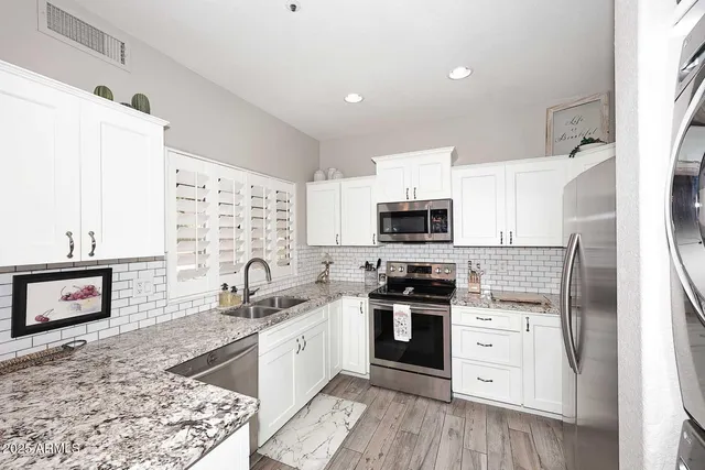 a large kitchen with a table and chairs