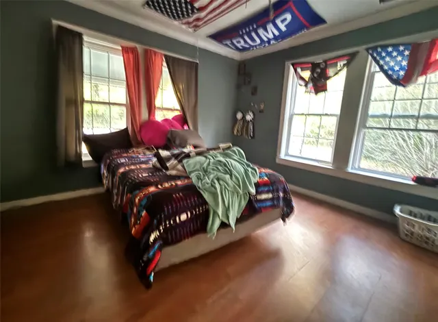 a bed sitting in a bedroom next to a window