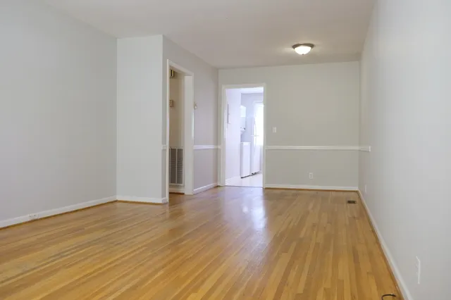 a view of a room with wooden floor