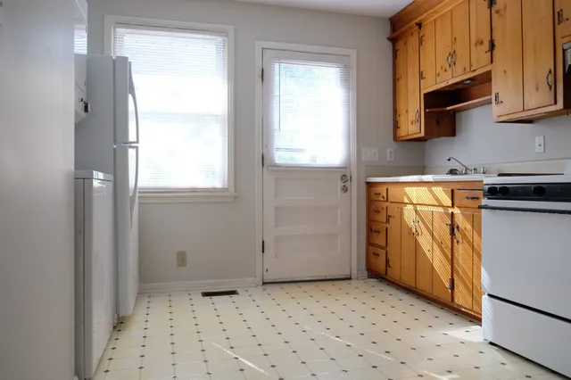 a kitchen with stainless steel appliances a refrigerator and a stove top oven