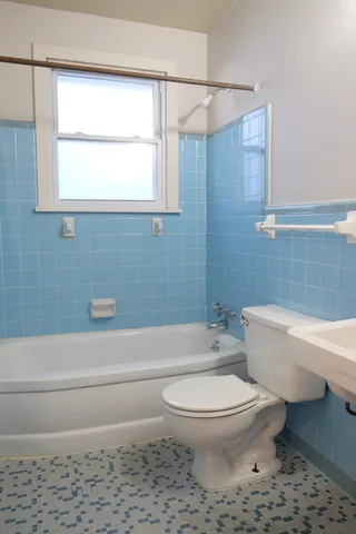 a bathroom with a toilet a sink and a bathtub