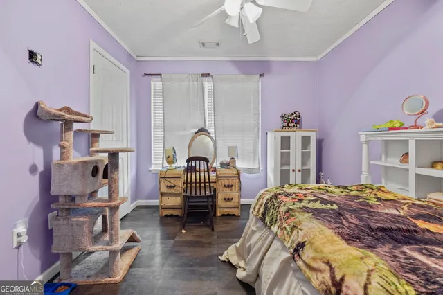 a bedroom with bed and a large window