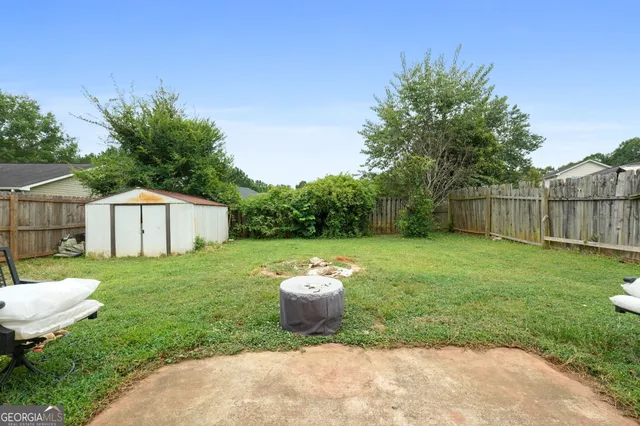 a view of a backyard with a garden and trees